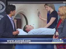 Two people on a TV show discuss a scene showing a patient and technician during a medical scan.