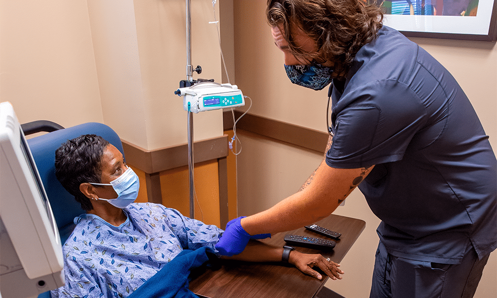 A cancer patient is administered Theranostics treatment through intravenous (IV) drip.